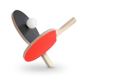 Image of Ping pong rackets and ball in air against white background