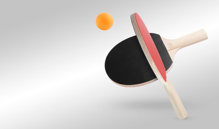 Image of Ping pong rackets and ball in air against light grey background. Banner design with space for text