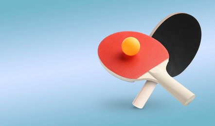 Image of Ping pong rackets and ball in air against light blue background. Banner design with space for text