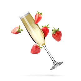 Image of Sparkling wine in flute glass and fresh strawberries falling against white background