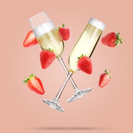 Image of Sparkling wine in flute glasses and fresh strawberries falling against pink background