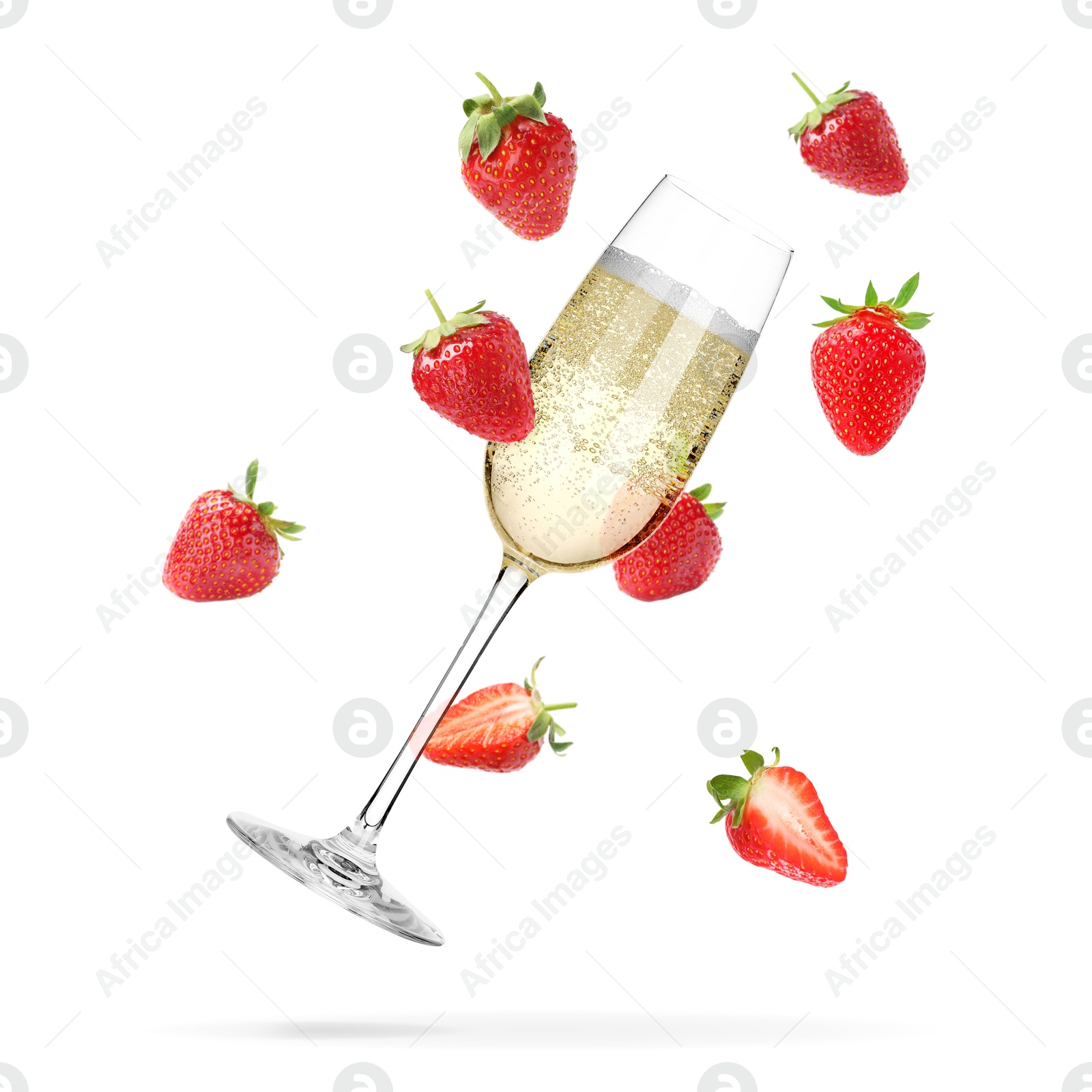Sparkling wine in glass and fresh strawberries falling against white background Image of Sparkling wine in glass and fresh strawberries falling against white background