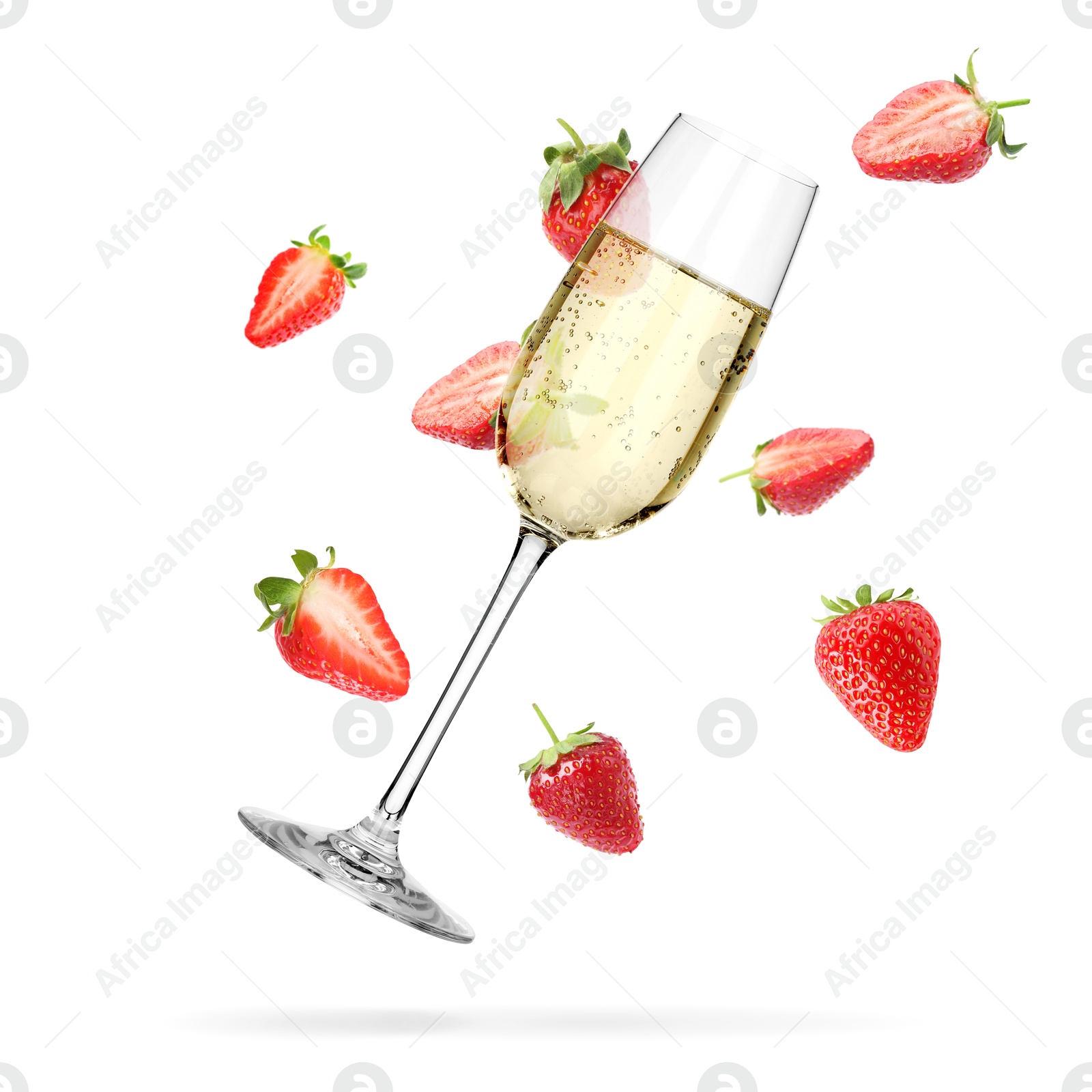 Image of Sparkling wine in glass and fresh strawberries falling against white background