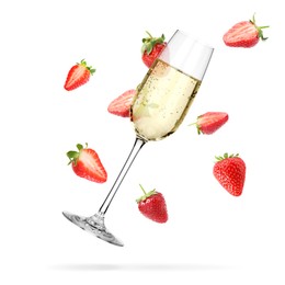 Image of Sparkling wine in glass and fresh strawberries falling against white background