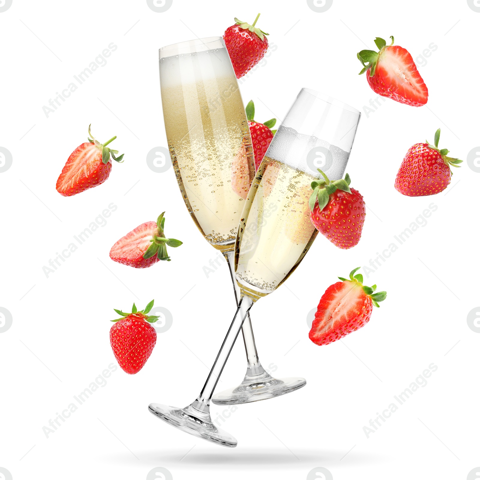 Image of Sparkling wine in flute glasses and fresh strawberries falling against white background