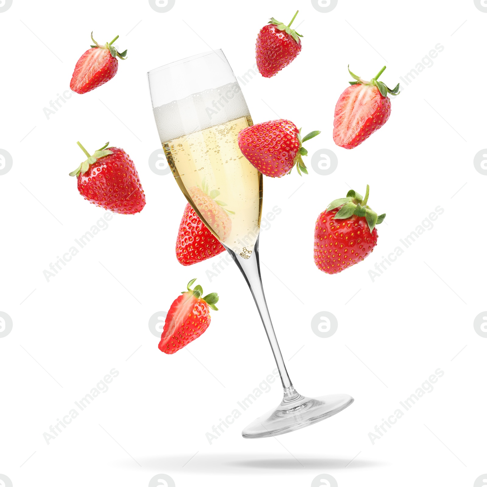 Sparkling wine in glass and fresh strawberries falling against white background Image of Sparkling wine in glass and fresh strawberries falling against white background