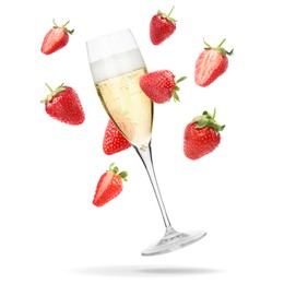 Image of Sparkling wine in glass and fresh strawberries falling against white background