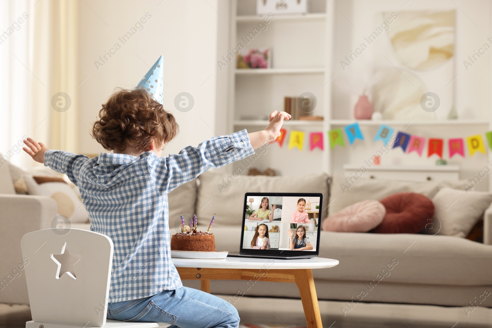 Celebrating birthday online. Little boy with cake having video call with friends via laptop at home Image of Celebrating birthday online. Little boy with cake having video call with friends via laptop at home