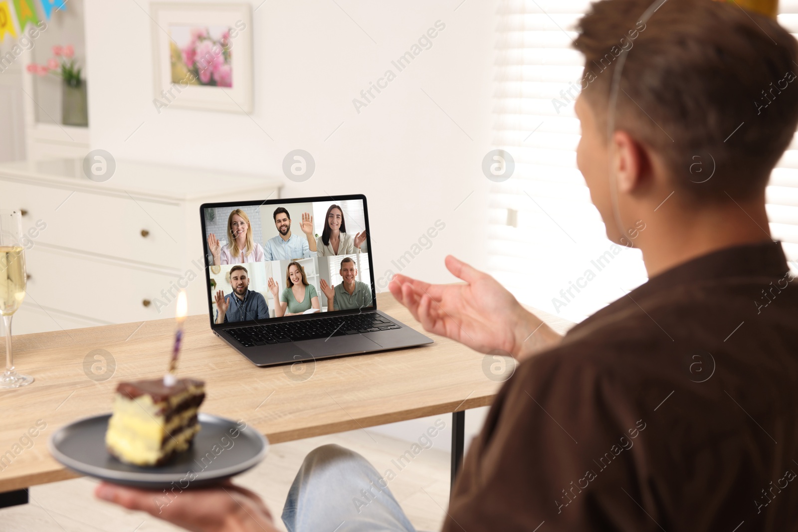 Celebrating birthday online. Man with cake having video call with friends via laptop at home Image of Celebrating birthday online. Man with cake having video call with friends via laptop at home