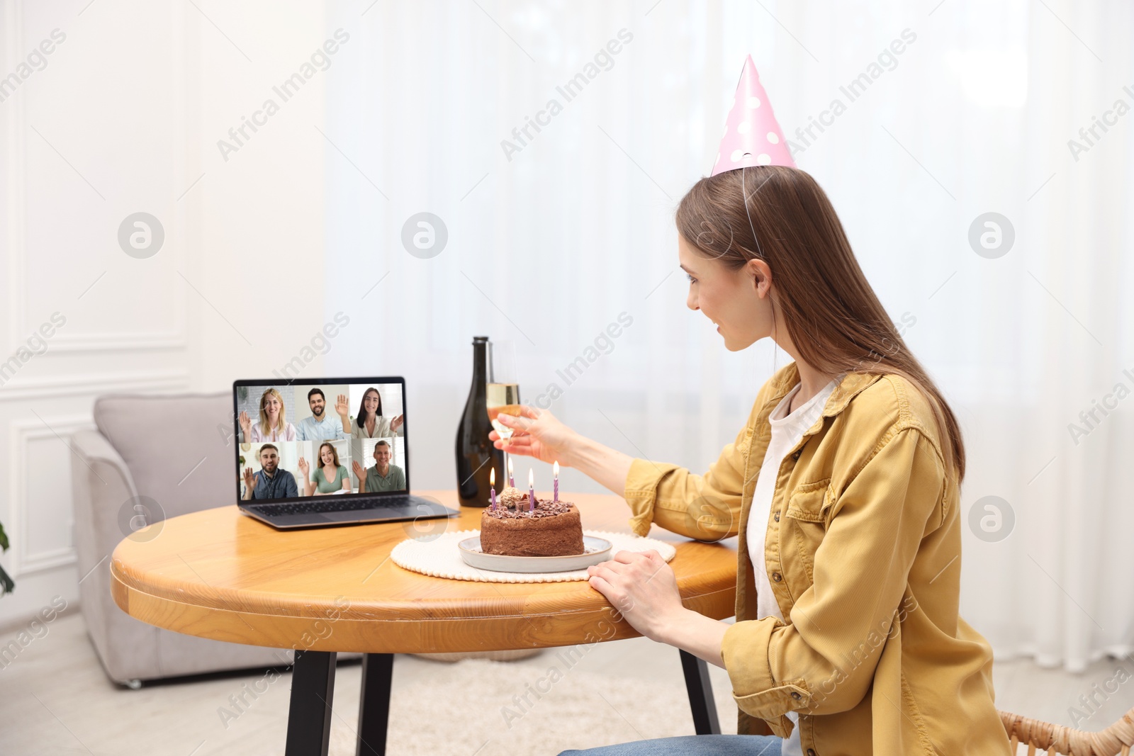Celebrating birthday online. Woman with sparkling wine and cake having video call with friends via laptop at home Image of Celebrating birthday online. Woman with sparkling wine and cake having video call with friends via laptop at home