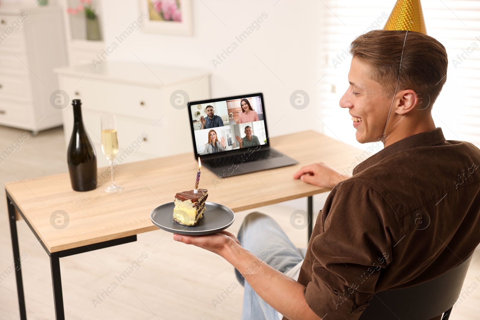 Celebrating birthday online. Man with cake having video call with friends via laptop at home Image of Celebrating birthday online. Man with cake having video call with friends via laptop at home
