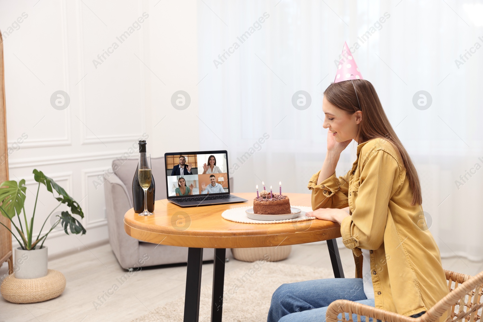 Celebrating birthday online. Woman with sparkling wine and cake having video call with friends via laptop at home Image of Celebrating birthday online. Woman with sparkling wine and cake having video call with friends via laptop at home