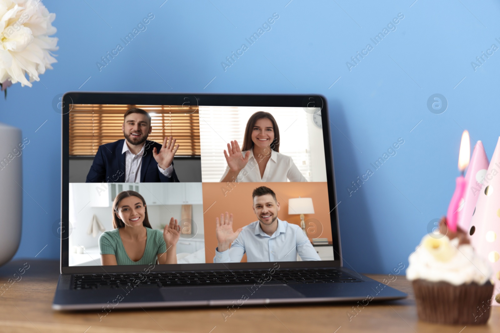 Celebrating birthday online. Video call with friends via laptop, cupcake on table indoors Image of Celebrating birthday online. Video call with friends via laptop, cupcake on table indoors