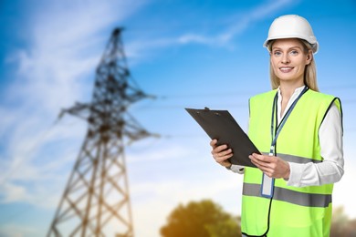 Image of Power engineer in hard hat holding clipboard against high voltage tower