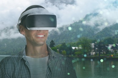 Image of Happy man using virtual reality headset, double exposure with mountain landscape