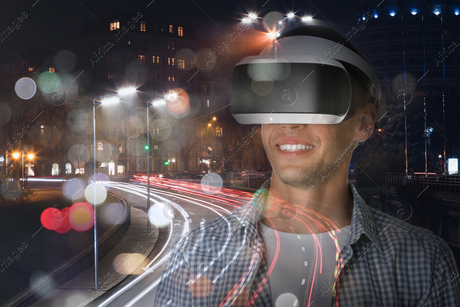 Happy man using virtual reality headset, double exposure with cityscape Image of Happy man using virtual reality headset, double exposure with cityscape