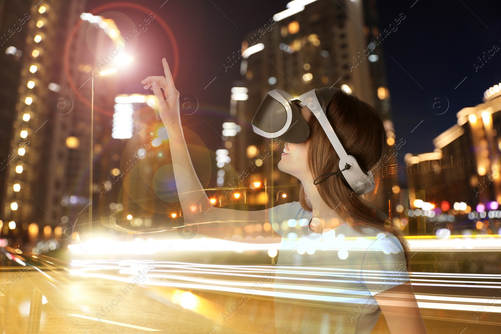 Happy woman using virtual reality headset, multiple exposure with cityscapes Image of Happy woman using virtual reality headset, multiple exposure with cityscapes