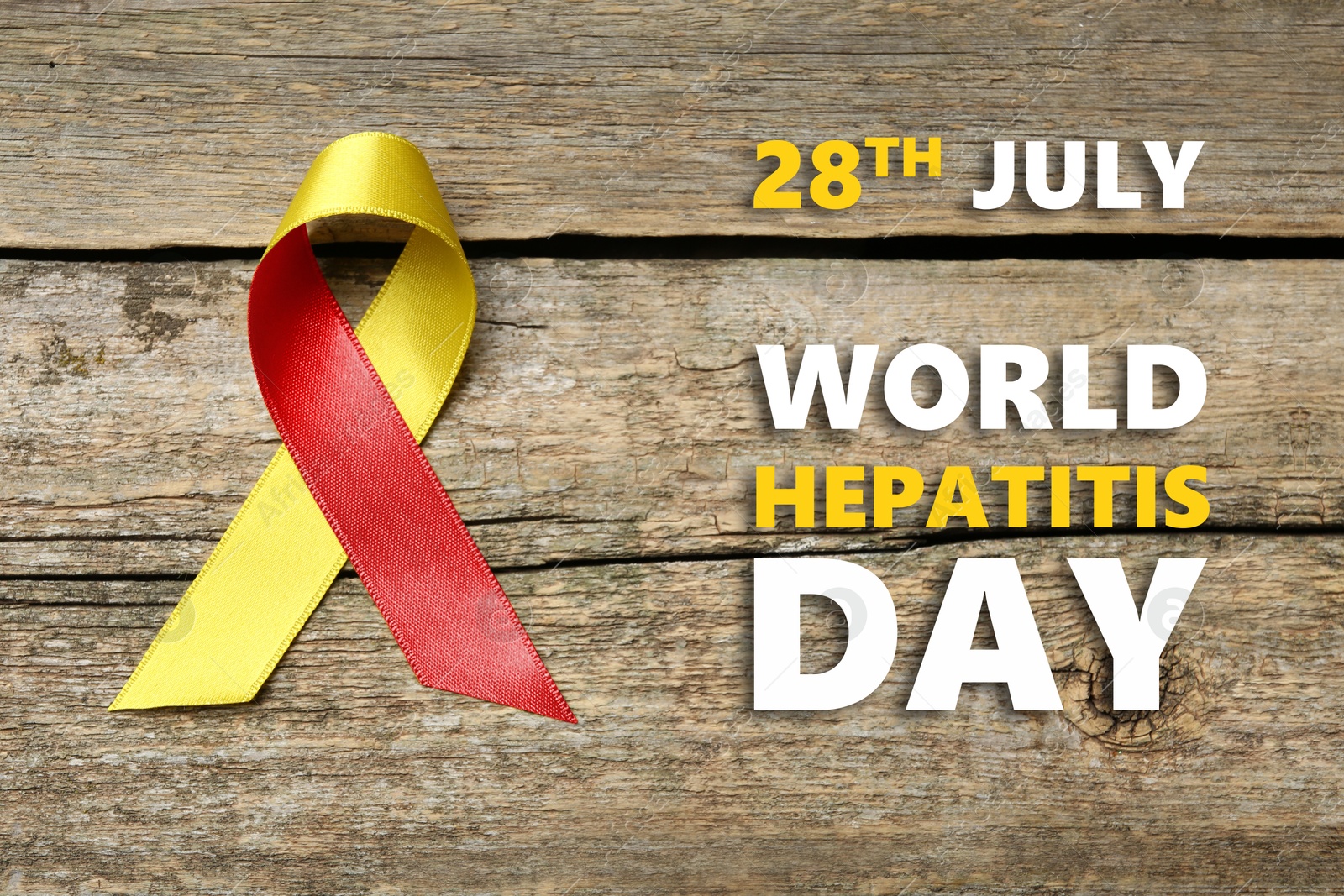 28th july World Hepatitis Day. Yellow-red awareness ribbon on wooden background, top view Image of 28th july World Hepatitis Day. Yellow-red awareness ribbon on wooden background, top view