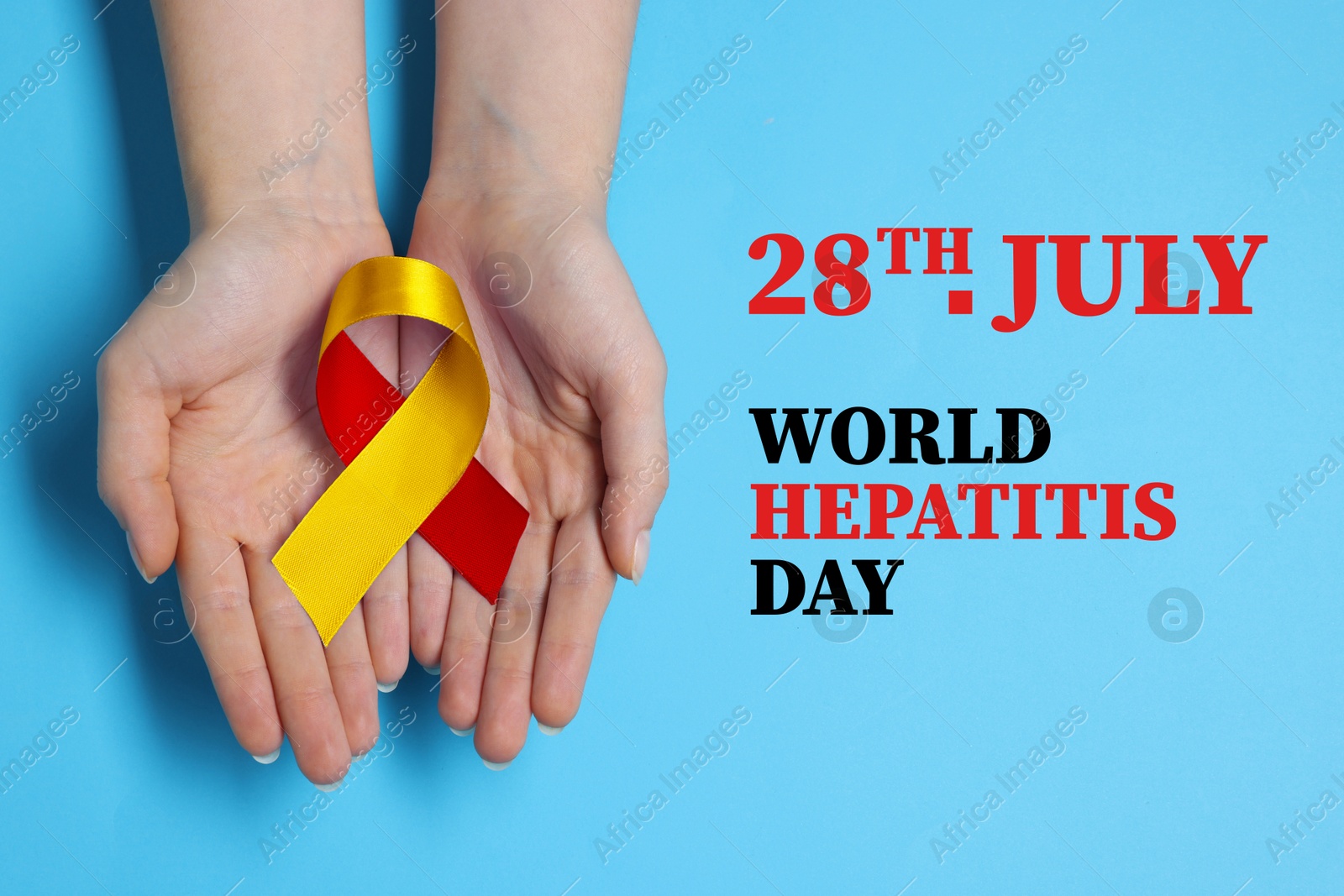 28th july World Hepatitis Day. Woman holding yellow-red awareness ribbon on light blue background, top view Image of 28th july World Hepatitis Day. Woman holding yellow-red awareness ribbon on light blue background, top view