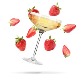 Image of Sparkling wine in glass and fresh strawberries falling against white background