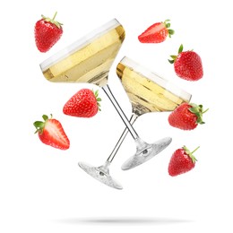Image of Sparkling wine in glasses and fresh strawberries falling against white background