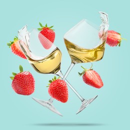 Image of Wine in glasses and fresh strawberries falling against light blue background