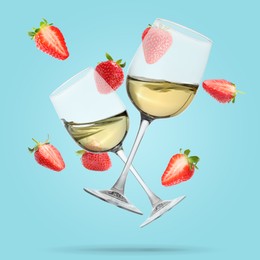 Image of Wine in glasses and fresh strawberries falling against light blue background