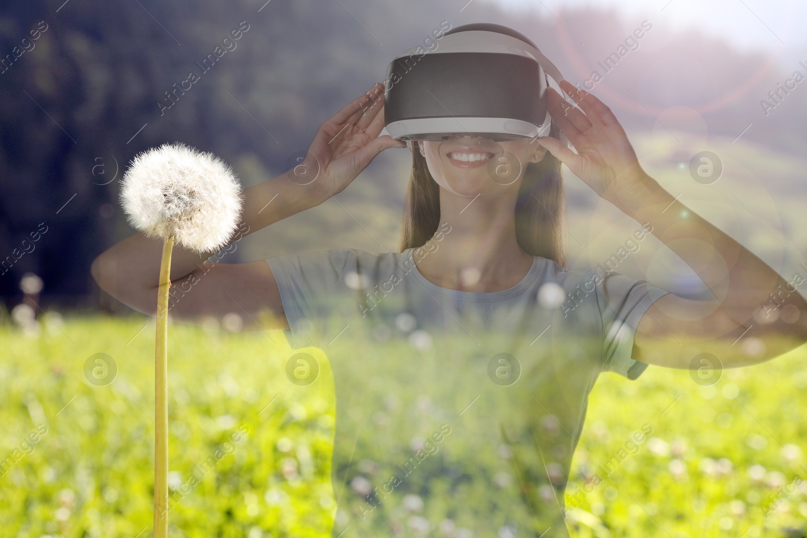Happy woman using virtual reality headset, double exposure with natural landscape Image of Happy woman using virtual reality headset, double exposure with natural landscape