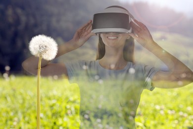 Image of Happy woman using virtual reality headset, double exposure with natural landscape