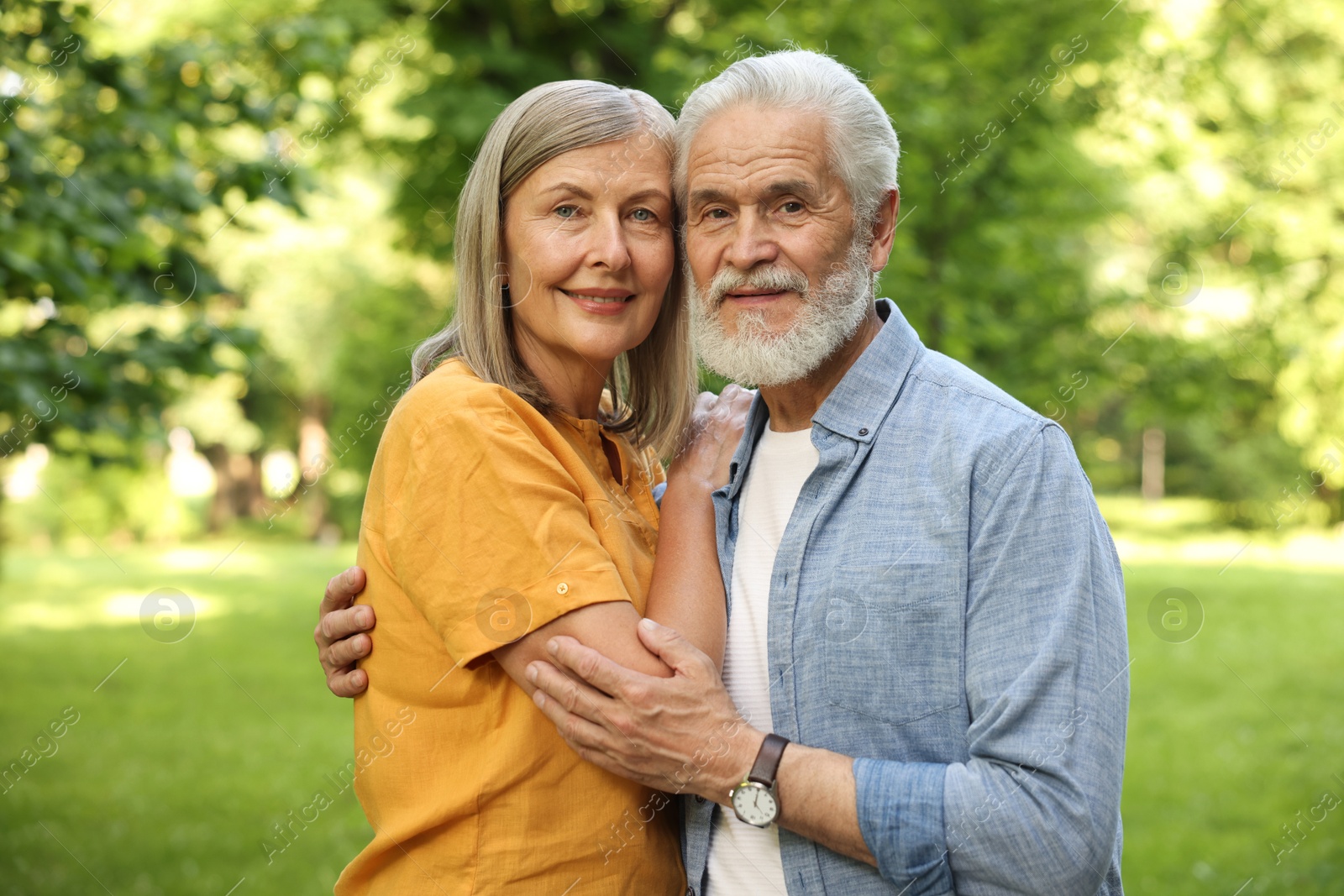 Photo of Lovely senior couple walking together in park