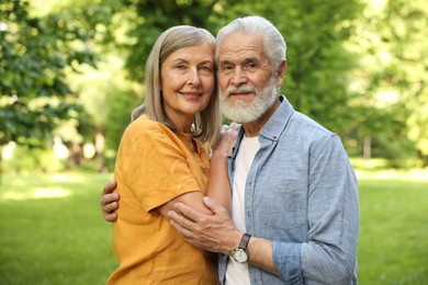 Photo of Lovely senior couple walking together in park