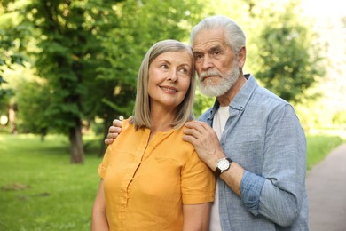 Photo of Lovely senior couple walking together in park