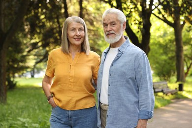 Photo of Lovely senior couple walking together in park
