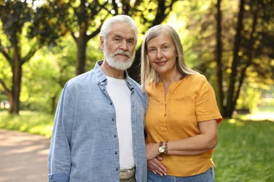 Photo of Lovely senior couple walking together in park