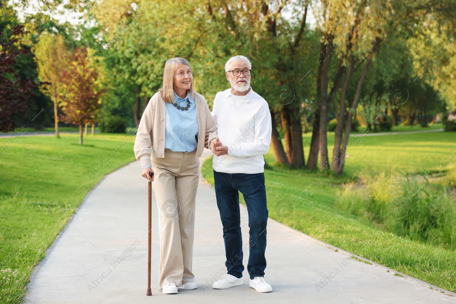 Lovely senior couple walking together in park Photo of Lovely senior couple walking together in park