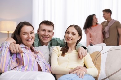 Photo of Friends hugging each other indoors, selective focus