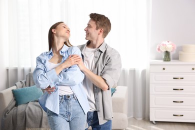 Photo of Happy couple dancing at home. Space for text