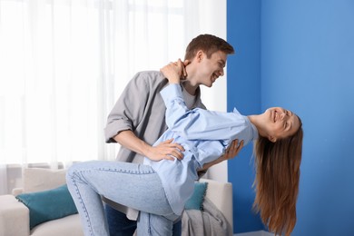 Photo of Happy young couple dancing together at home