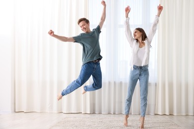 Photo of Happy young couple dancing together at home