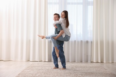 Photo of Happy young couple dancing together at home