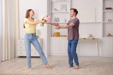 Photo of Happy young couple dancing together at home