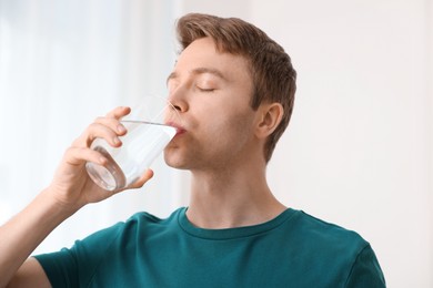 Photo of Man drinking water from glass at home
