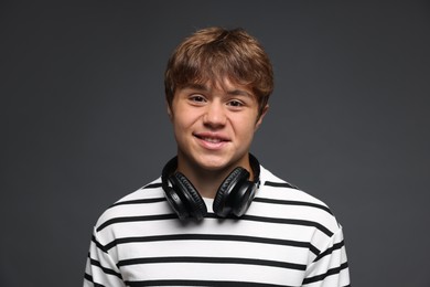 Photo of Portrait of smiling teenage boy on grey background