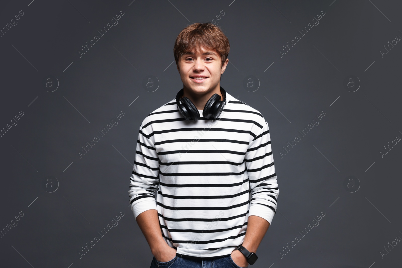 Photo of Portrait of smiling teenage boy on grey background