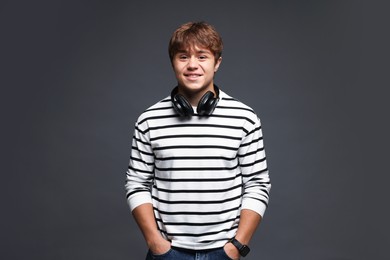 Photo of Portrait of smiling teenage boy on grey background