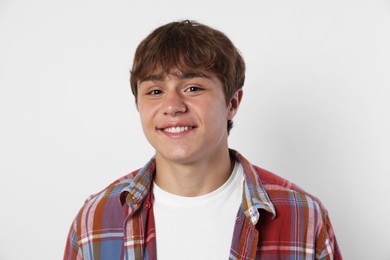 Photo of Portrait of smiling teenage boy on light grey background