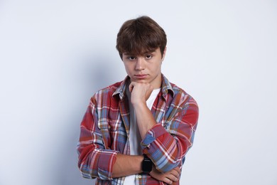 Photo of Portrait of cute teenage boy on light grey background