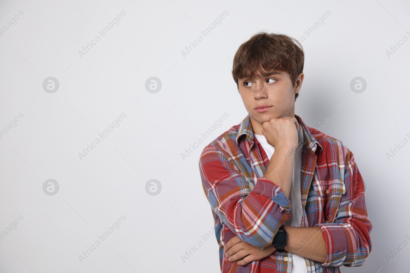 Photo of Cute teenage boy on light grey background. Space for text