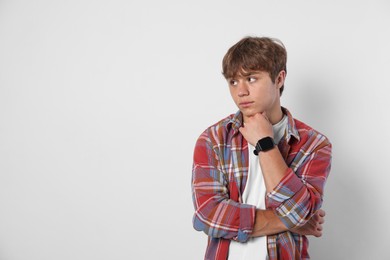 Photo of Cute teenage boy on light grey background. Space for text