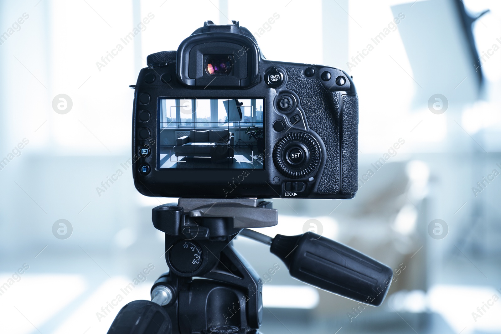 Photo of Shooting sofa with professional photo camera in studio, selective focus
